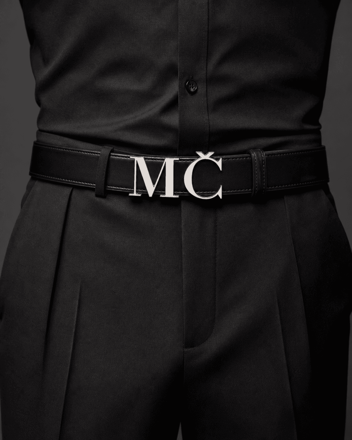Black MČ logo belt worn with black tailoring
